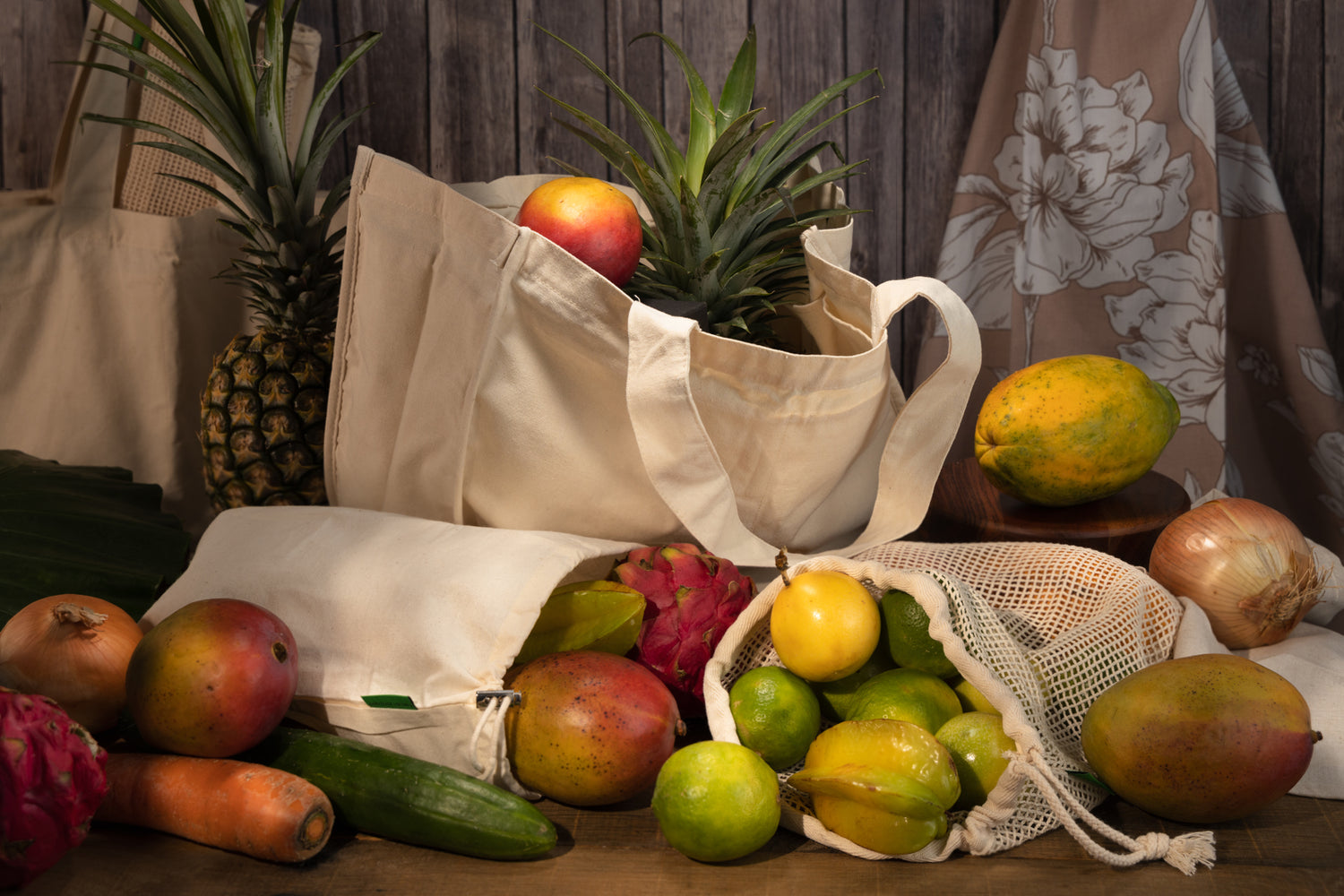 This image shows the Desesh range of reusable unbranded cotton grocery tote bags and produce bags. The bags are full of tropical fruit. These are a part of Desesh's range of zero waste, plastic free, eco friendly, more sustainable personal care and everyday essential products.