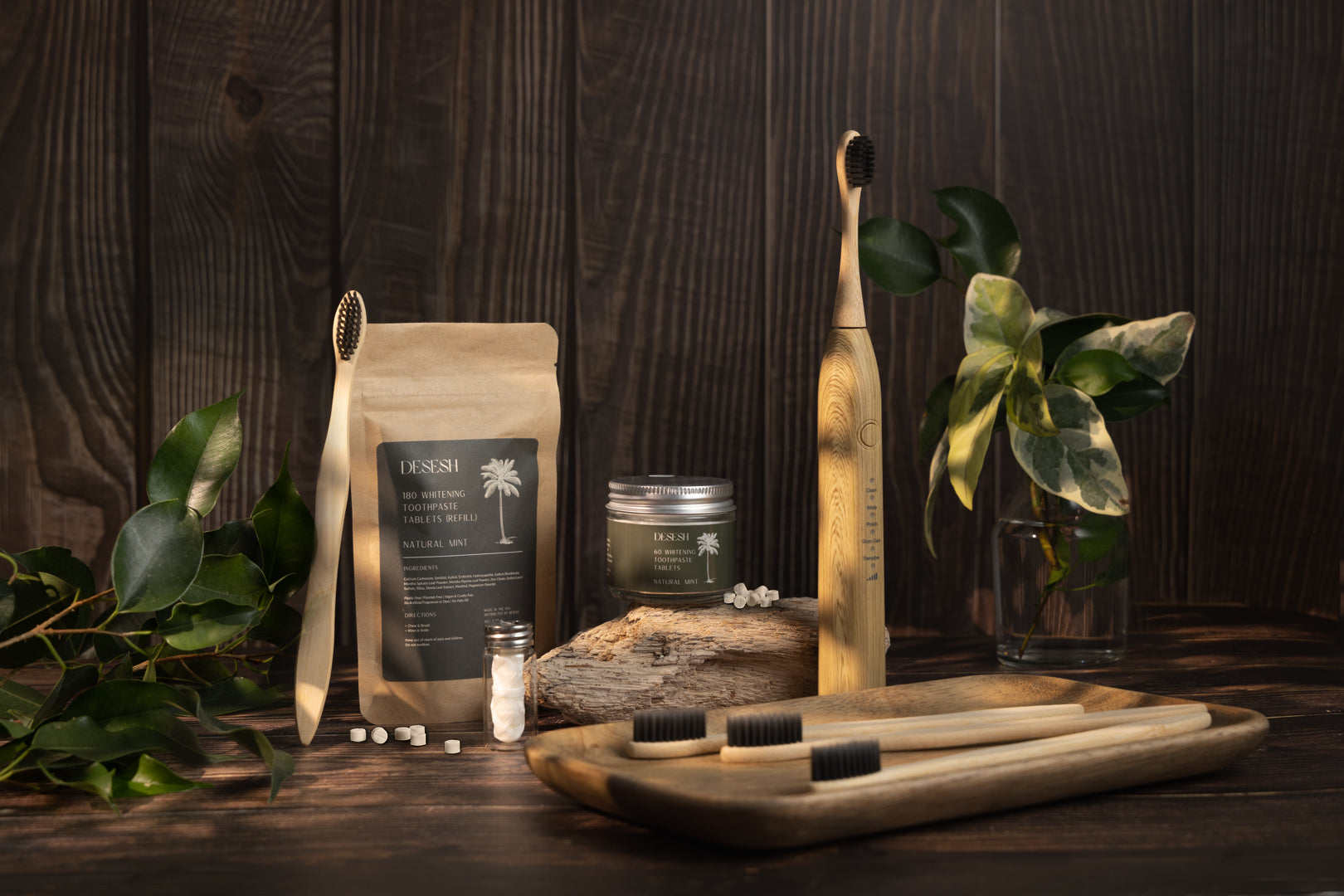 Desesh collection of more sustainable eco friendly plastic free zero waste dental and oral care products including toothpaste tablets, biodegradable dental floss, bamboo electric sonic toothbrush, and bamboo manual toothbrush