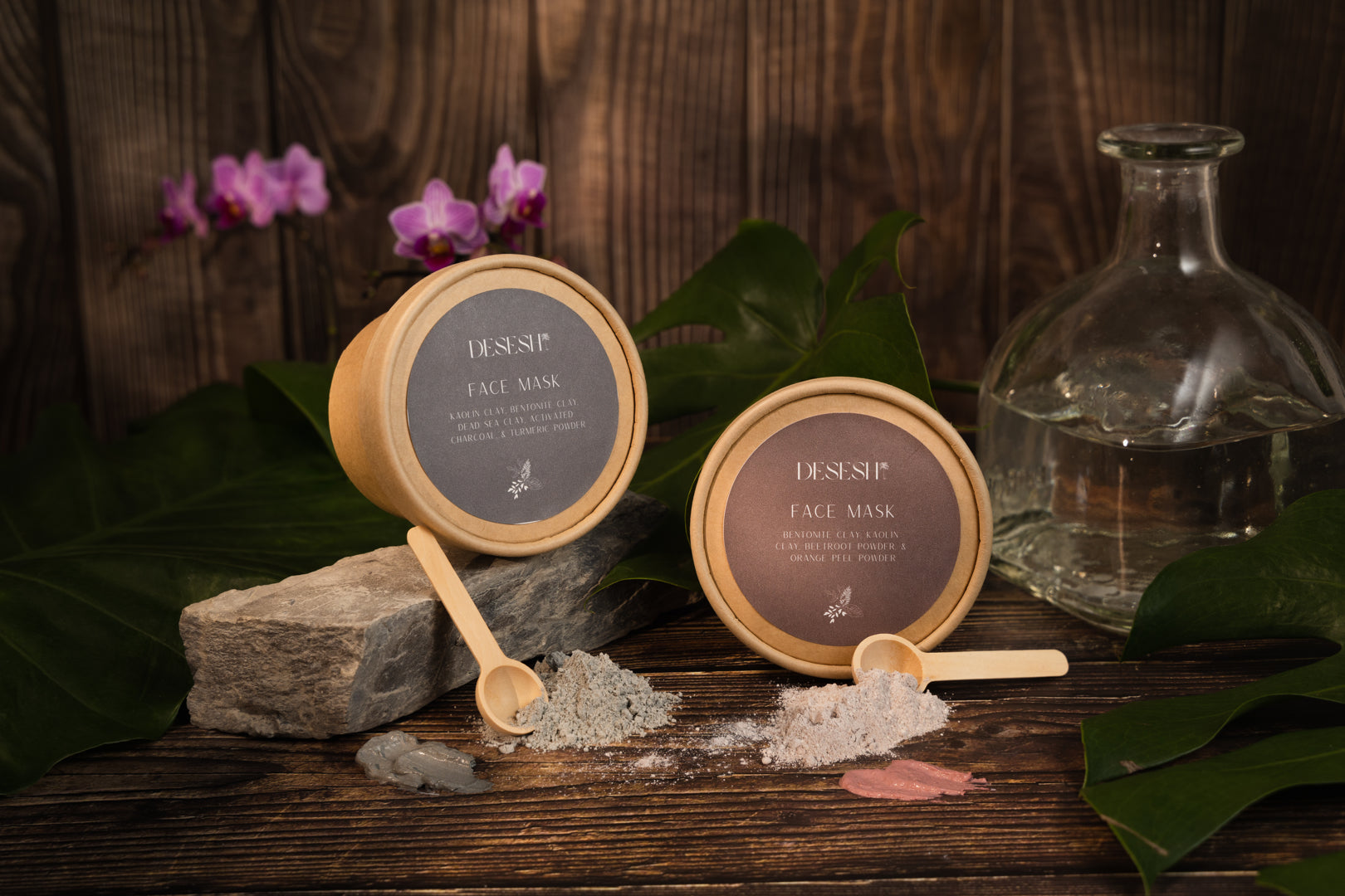 This image shows the Desesh US-made spa quality mineral face mask powder as an alternative to single use face mask sheets for a more environmentally friendly zero waste plastic free self care face mask routine. The image shows both of the Desesh mineral face mask products in a stylized setting with plants and natural materials