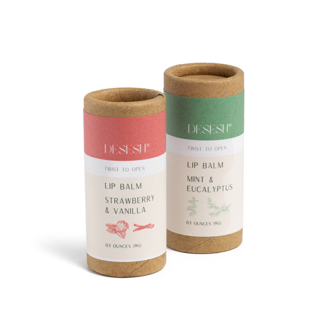 This image shows the Desesh natural plastic free lip balm in a paper based cardboard push up tube for a more eco friendly sustainable zero waste lip balm. Shown here are both scent options
