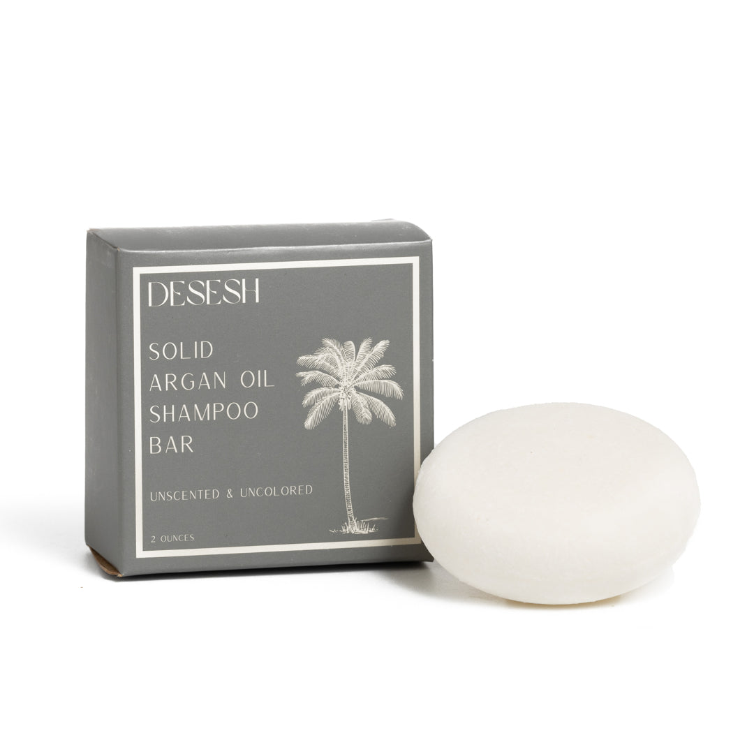 This image shows salon quality Argan Oil Shampoo bars with plastic free biodegradable packaging for a more sustainable eco friendly zero waste hair care routine. Shown here is the unscented and uncolored solid shampoo bar.