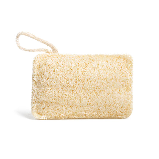 This image shows a natural loofah exfoliating pad which is used to scrub skin to exfoliate. It is a plastic free product designed for a more eco friendly zero waste sustainable routine