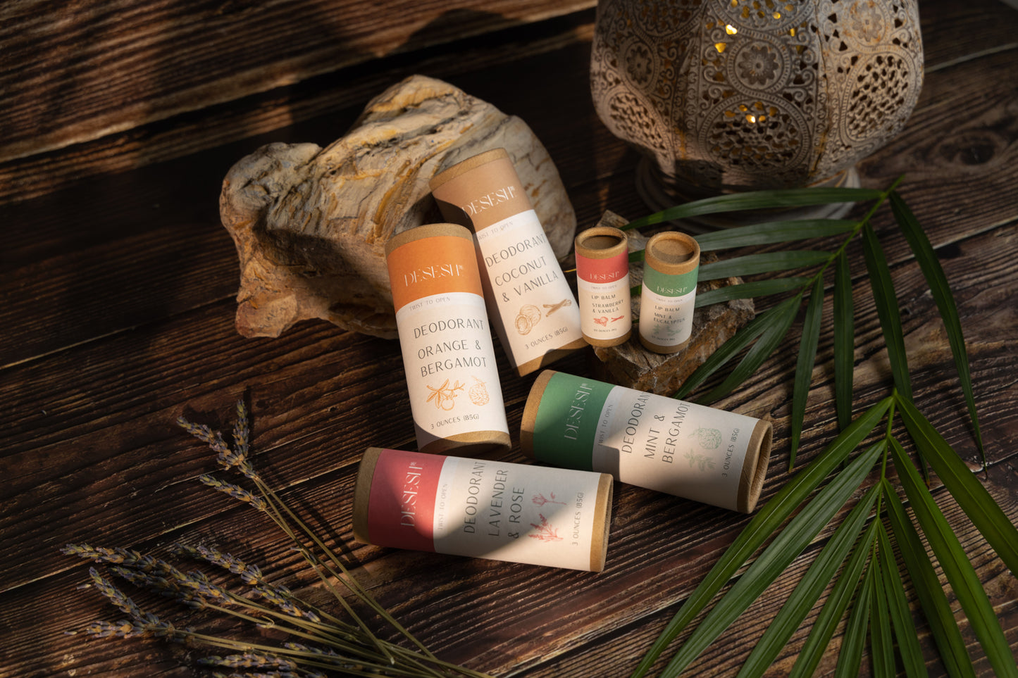 This image shows the Desesh natural plastic free lip balm in a paper based cardboard push up tube for a more eco friendly sustainable zero waste lip balm. Shown here are the natural lip balm and deodorant products that Desesh offers