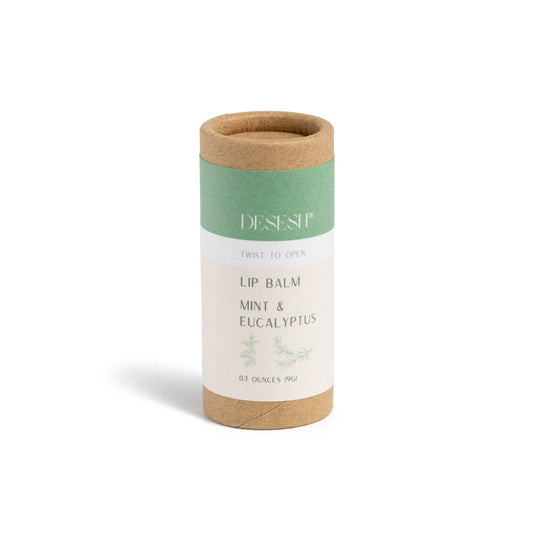 This image shows the Desesh natural plastic free lip balm in a paper based cardboard push up tube for a more eco friendly sustainable zero waste lip balm. Shown here is the mint and eucalyptus flavor which uses essential oils as a natural fragrance