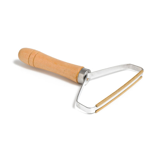 This image shows a reusable bamboo and metal lint remover as an alternative to single use disposable plastic lint rollers. This is designed for a plastic free zero waste more sustainable eco friendly routine and lifestyle