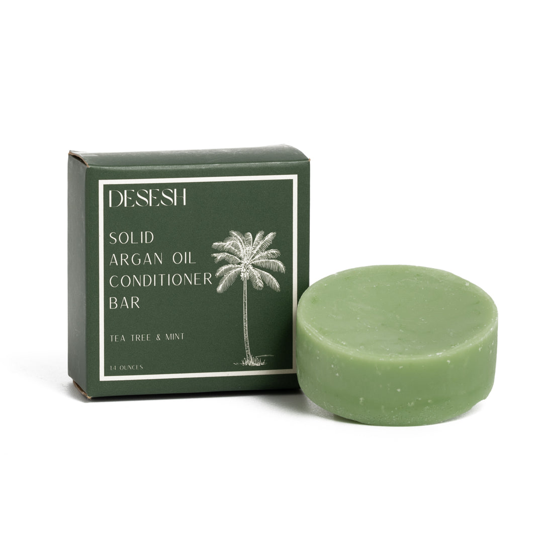 This image shows salon quality Argan Oil solid conditioner bars with plastic free biodegradable packaging for a more sustainable eco friendly zero waste hair care routine. Shown here is the Tea Tree and Mint solid conditioner bar with natural scents and colors.