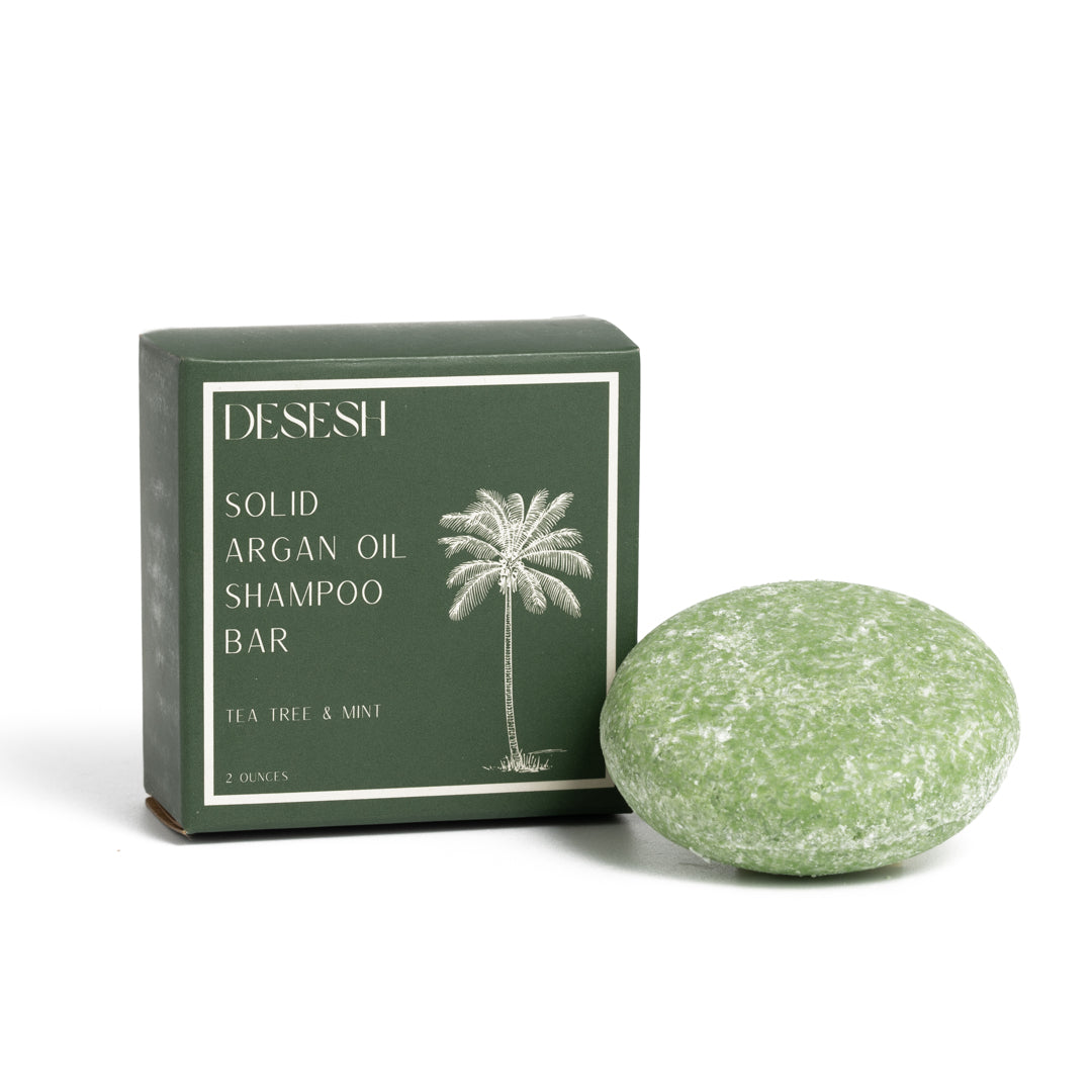 This image shows salon quality Argan Oil Shampoo bars with plastic free biodegradable packaging for a more sustainable eco friendly zero waste hair care routine. Shown here is the Tea Tree and Mint solid shampoo bar.