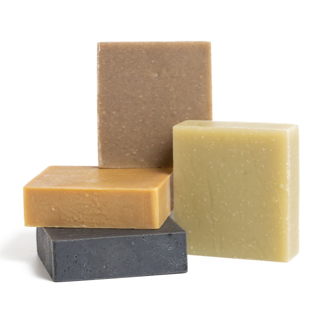 This photo shows the Desesh premium quality US-made small batch body hand and face soap bar with plastic free biodegradable packaging. In the image are the four options for natural soap bars with no artificial fragrances or colors