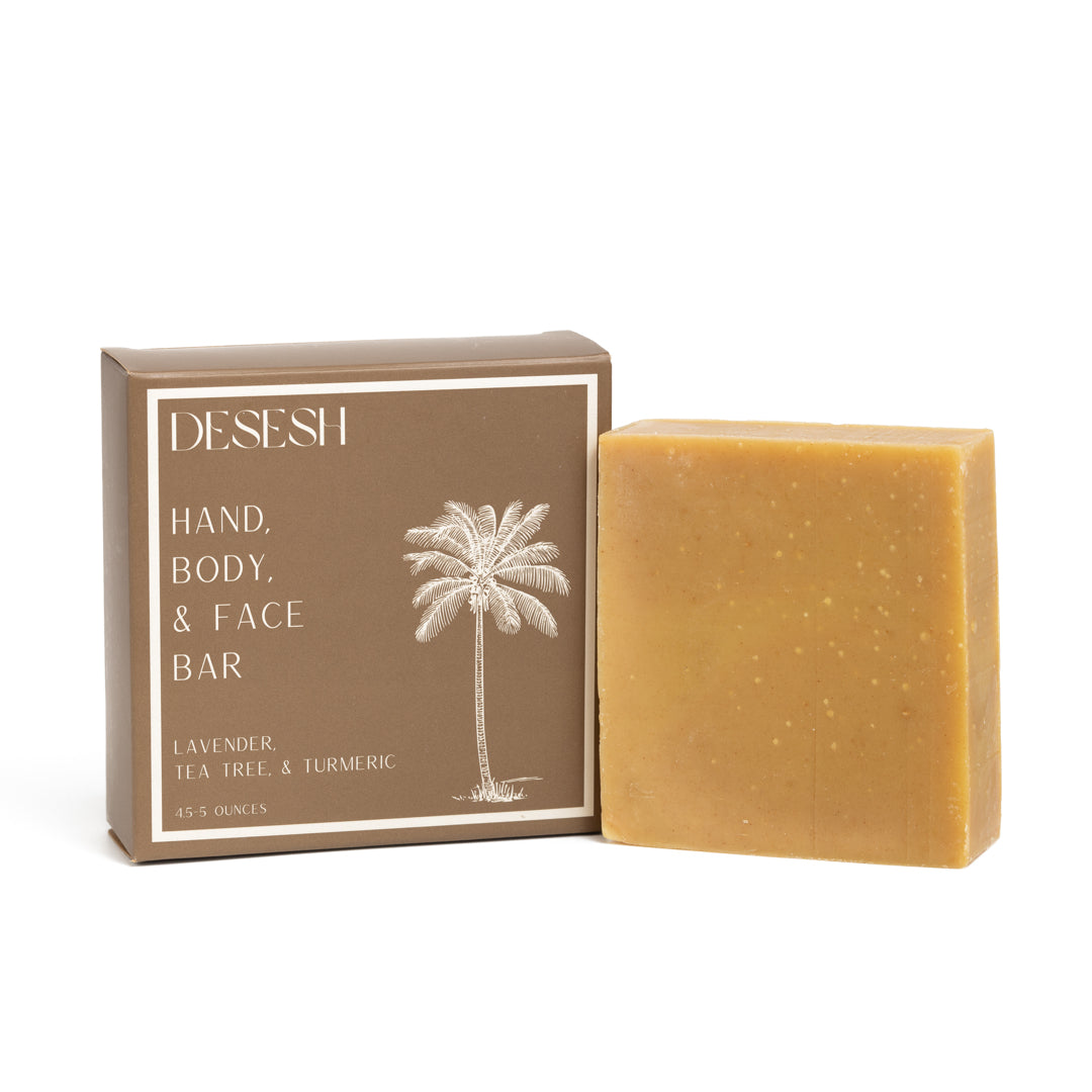 This photo shows the Desesh premium quality US-made small batch body hand and face soap bar with plastic free biodegradable packaging. In the image is the lavender tea tree and turmeric soap bar