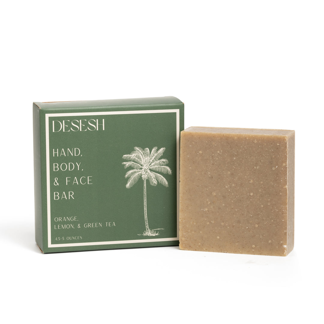 This photo shows the Desesh premium quality US-made small batch body hand and face soap bar with plastic free biodegradable packaging. In the image is the orange lemon and green tea soap bar