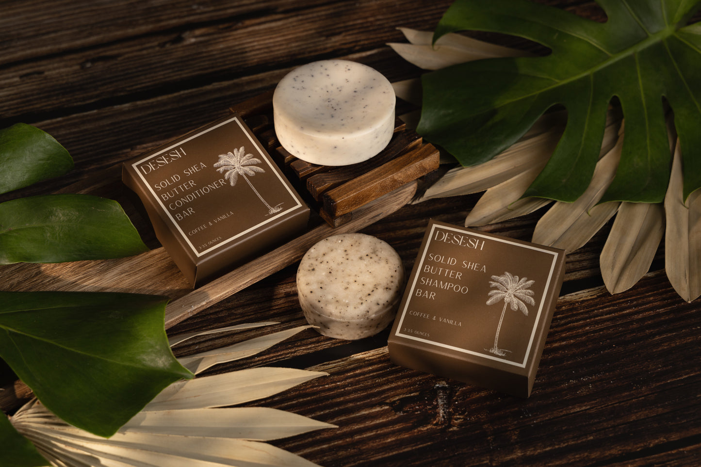 This image shows salon quality Shea Butter solid shampoo bars with plastic free biodegradable packaging for a more sustainable eco friendly zero waste hair care routine. Shown here are the coffee and vanilla solid shampoo and conditioner bars with their biodegradable packaging