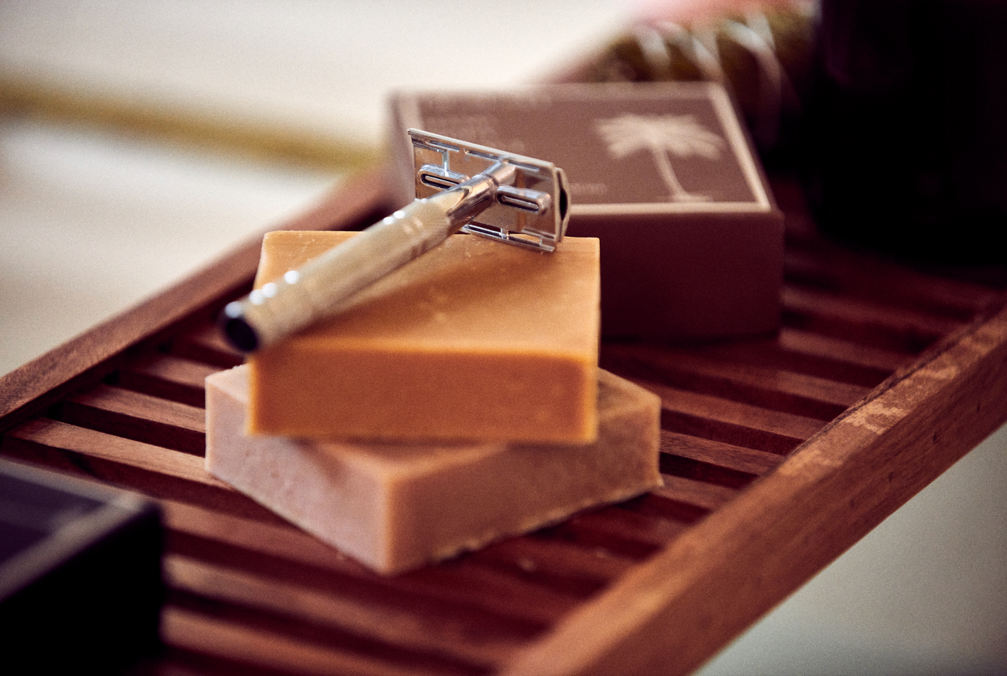 This image shows the Desesh premium quality solid body and face shave soap bar as an alternative to cans of shave foam or cream. This is a more eco friendly sustainable zero waste option and the shave bars come in biodegradable packaging. Shown here is the metal safety razor and two of the solid shave soap bars